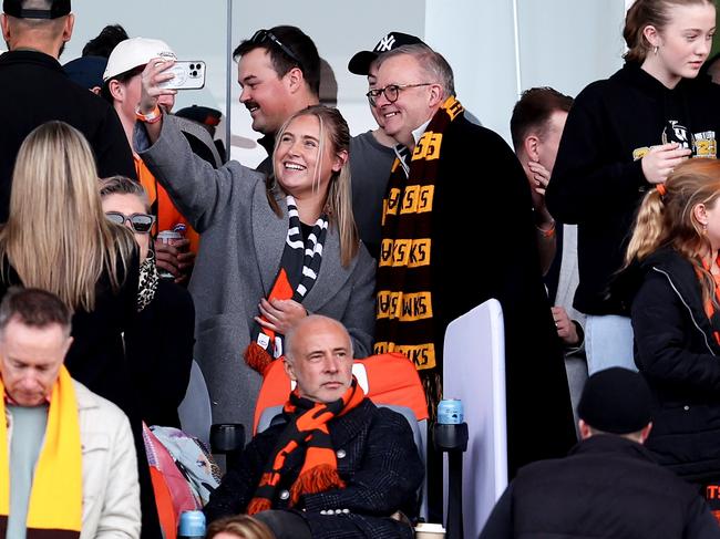 Hawthorn fan Anthony Albanese poses for photos with fans during the round 21 AFL match between the Giants and Hawks. Picture: Getty