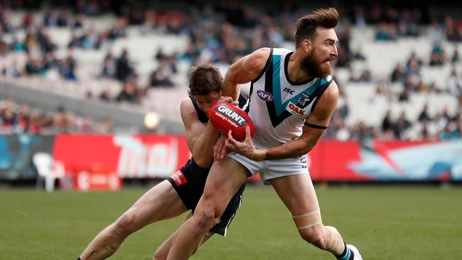 The Power’s Charlie Dixon tries to escape a tackle from Carlton’s Sam Rowe. Picture: Michael Willson/AFL Media/Getty Images