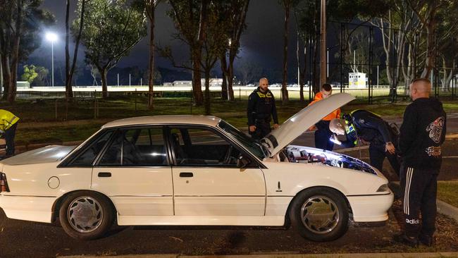 Police inspect a car. Picture: Mark Stewart