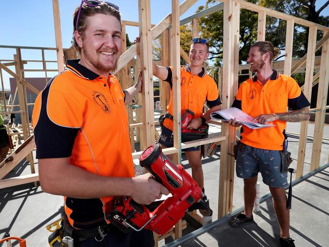 TAFE carpentry apprentices Ethan Sutherland and Karl Van Rijssen with apprentice manager Steve Purcell working on a 54-townhouse development at Richlands. Picture: Tara Croser.