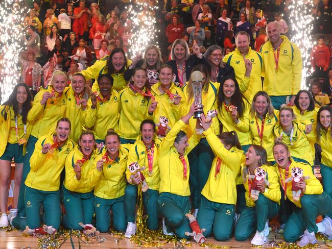 TOPSHOT - Australian players hold their trophy as they celebrate winning the final of the Netball World Cup against England, in Cape Town on 06 August 2023. (Photo by RODGER BOSCH / AFP)