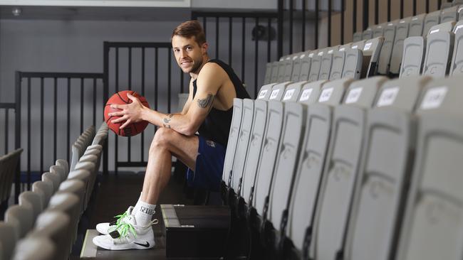 Brisbane Bullets signing Nathan Sobey at the club’s new home at the Queensland State Netball Centre.