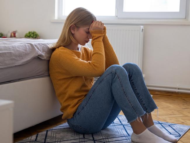 Bored young woman in bedroom