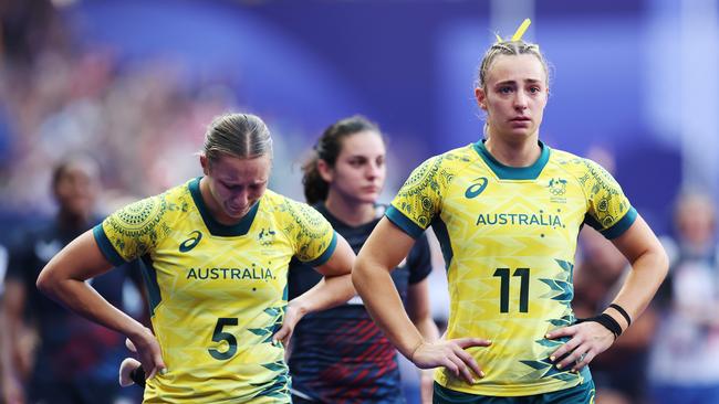 PARIS, FRANCE - JULY 30: Teagan Levi #5 and Bridget Clark #11 of Team Australia of Team Australia looks dejected following defeat during the Women's Rugby Sevens Bronze medal match between Team Canada and Team Australia on day four of the Olympic Games Paris 2024 at Stade de France on July 30, 2024 in Paris, France. (Photo by Cameron Spencer/Getty Images)