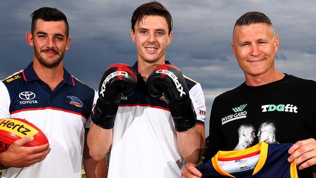 Taylor Walker and Jake Lever with boxer Danny Green. Picture: Simon Cross