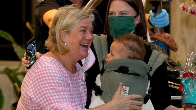 Ali Sherry, left, greets her daughter Sarah Cowley and granddaughter Zara as she leaves the Westin in Brisbane. Picture: David Clark