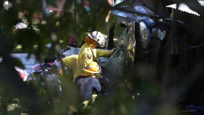 Firefighters attempt to free Tara from her car wreck. Picture by Scott Fletcher