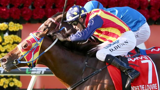 Victorian visitor Under The Louvre narrowly clinches Queensland’s premier race, the Group 1 Stradbroke Handicap, from a gallant Black Heart Bart on June 11. Picture: Jono Searle