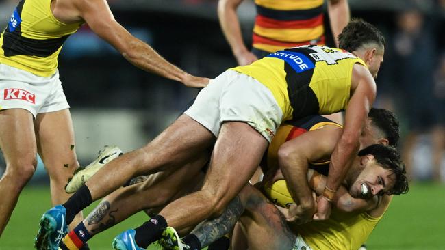 Lachlan Murphy of the Crows tackled by Jack Graham and Tim Taranto of the Tigers. Picture: Mark Brake.