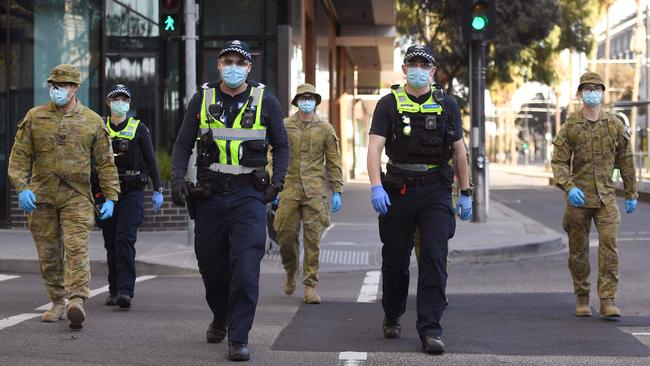 A group of police and soldiers patrolling Melbourne during last year’s lockdown. Picture: William West/AFP