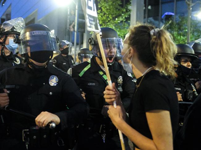 Police officers move forward to clear the street during a protest in downtown Los Angeles. Picture: AP