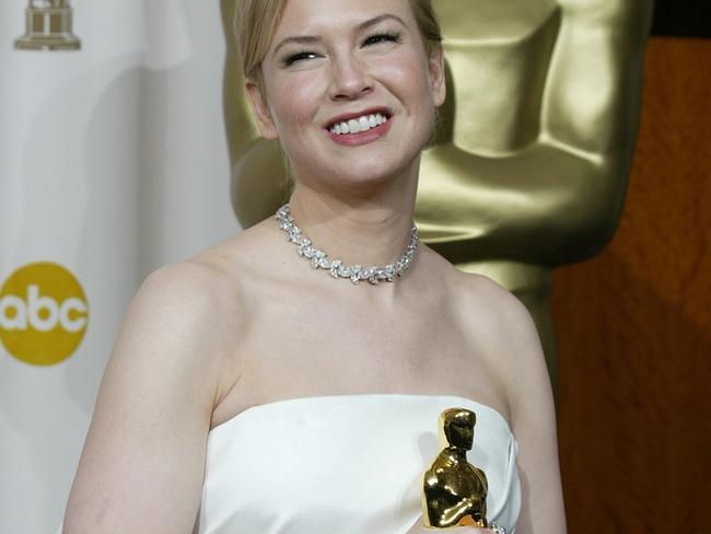 Renée Zellweger poses with her Oscar she won for Best Supporting Actress.