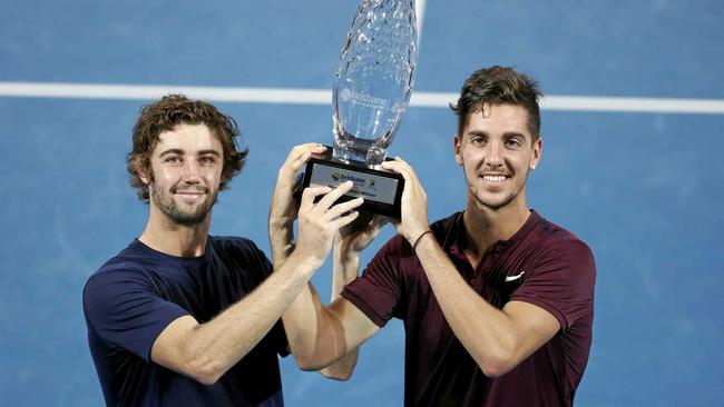 HE'S BACK: Thanasi Kokkinakis (right) and fellow Australian Jordan Thompson celebrate their win in the final of the men's doubles at the Brisbane International. Picture: DAVE HUNT