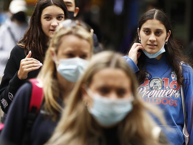 MELBOURNE, AUSTRALIA - NOVEMBER 23: People are seen without face masks on November 23, 2020 in Melbourne, Australia. COVID-19 restrictions have relaxed further in Victoria as the state continues to record no new coronavirus cases. From Monday, Victorians no longer need to wear masks when outside at all times, with people only required to wear masks when indoors and on public transport, or in places outside where social distancing is not possible. Under the relaxed rules, people will also be allowed to have up to 15 people in their home each day while public gatherings of up to 50 people are permitted outdoors. Capacity limits for cafes, bars and restaurants, along with gyms, indoor sporting venues, cinemas and indoor entertainment along with community venues have also increased. (Photo by Daniel Pockett/Getty Images)