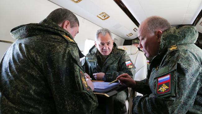 Russian Defence Minister Sergey Shoigu, centre, and Chief of the Russian General Staff Valery Gerasimov. left, discuss the military drills taking place at the Opuk training ground in eastern Crimea. Picture: AFP