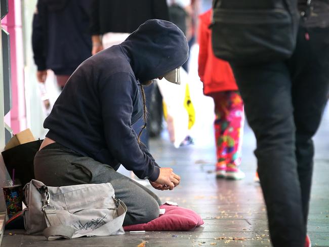 Homeless not Homeless. Police have charged 33 professional and aggressive beggars in a CBD operation during the Australian Open. Police say that most of them have houses in the suburbs and usually drive into town to beg, some with pets to attract sympathy. A possible beggar  on Swanston Street counts his money.    Picture: David Caird