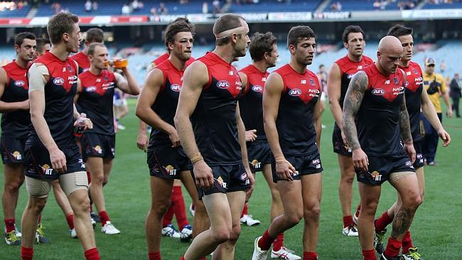 A dejected group of Demons leave the field. Picture Wayne Ludbey.