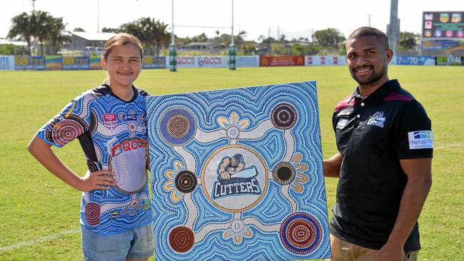 Charli Bliss and Jayden Hodges with Charli's original artwork that has been immortalised on the Cutters' Indigenous round jersey. Picture: Stuart Quinn