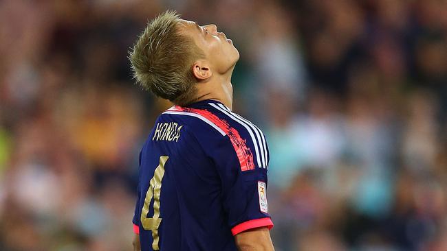 Keisuke Honda of Japan reacts after missing the first penalty of the shootout.