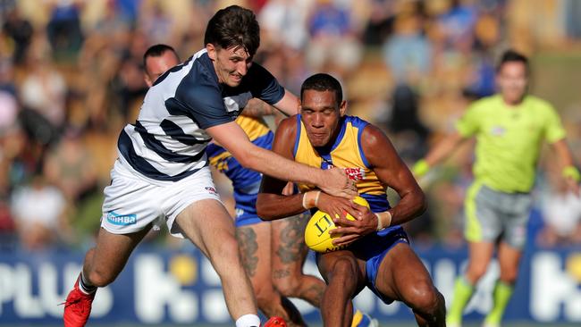 Francis Watson (right) of the Eagles is tackled by Charlie Constable of the Cats during the AFL JLT Community Series. (AAP Image/Richard Wainwright)