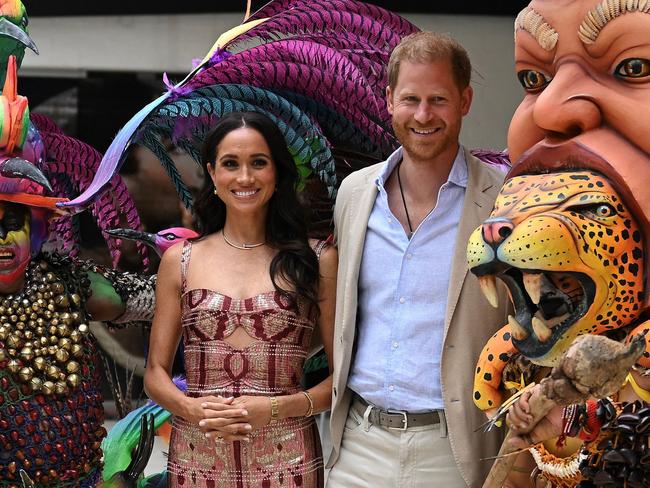 Prince Harry and his wife Meghan Markle pose with dancers during a visit to the National Centre for the Arts in Bogota. Picture: AFP