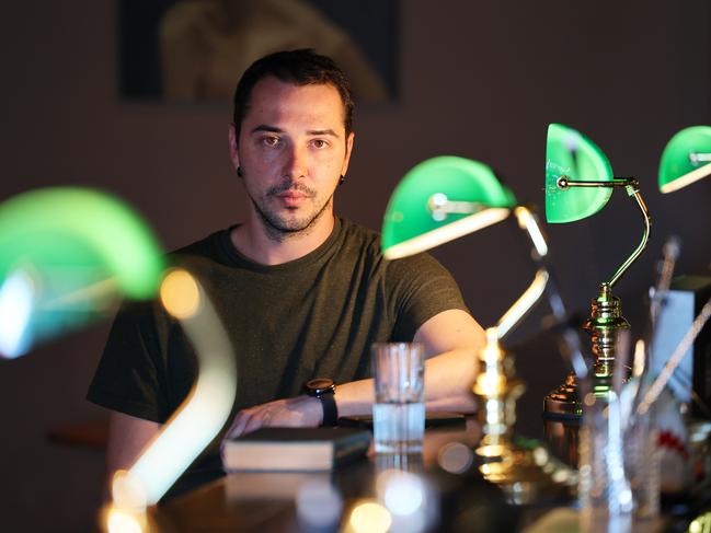 Roman Tazhdynov in his Bibliotheca bar in Adelaide. Picture: David Mariuz