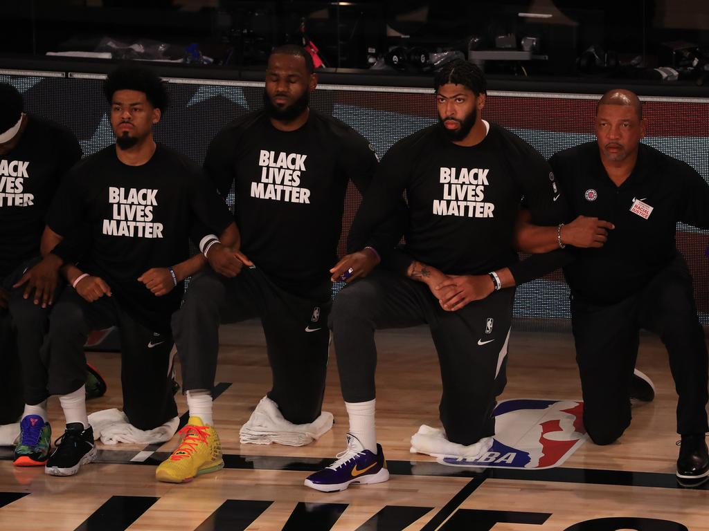 LeBron James (second from right) and Doc Rivers (far right) kneel in support of Black Lives Matter. (Photo by Mike Ehrmann/Getty Images)