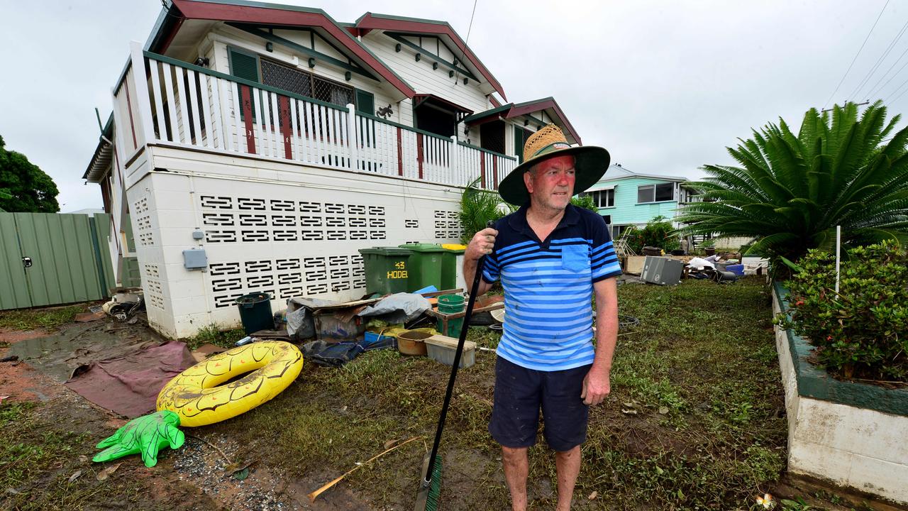 Townsville Floods. Hermit Park resident Kevin Warren helps clean his neighbour's Hodel Street home. Picture: Evan Morgan