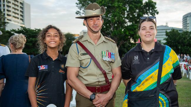 Azaria Bretherton, Alan Hubbard and Aurora Van Den Berg Hammer as Territorians gather in Darwin City to reflect on Anzac Day. Picture: Pema Tamang Pakhrin