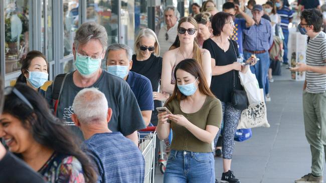 People queue at a supermarket after the South Australian state government announced a six-day lockdown.