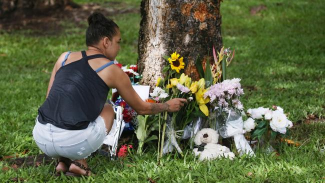 Scene of a fatal traffic crash at Manoora, where an allegedly stolen Toyota Yaris left Pease Street near the Saltwater Creek Bridge and crashed into a tree. 14-year-old Bradley Smith was declared dead at the scene, and 5 other children aged 12 to 15 were taken to Cairns Hospital with injuries. Denise Weazael of Manoora lays some flowers at the scene of the crash. Picture: Brendan Radke