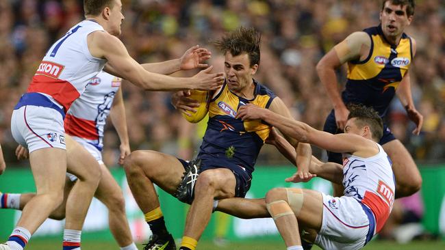 Dom Sheed under pressure from Jack Macrae and Luke Dahlhaus. Picture: Daniel Wilkins