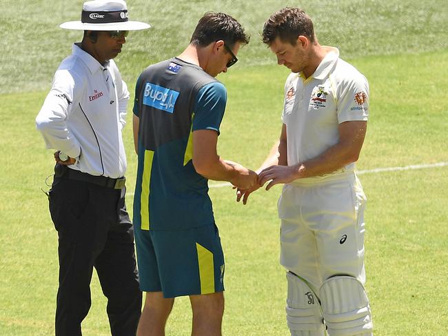 Tim Paine has his finger looked during a Test match in 2018. Picture: Quinn Rooney/Getty Images