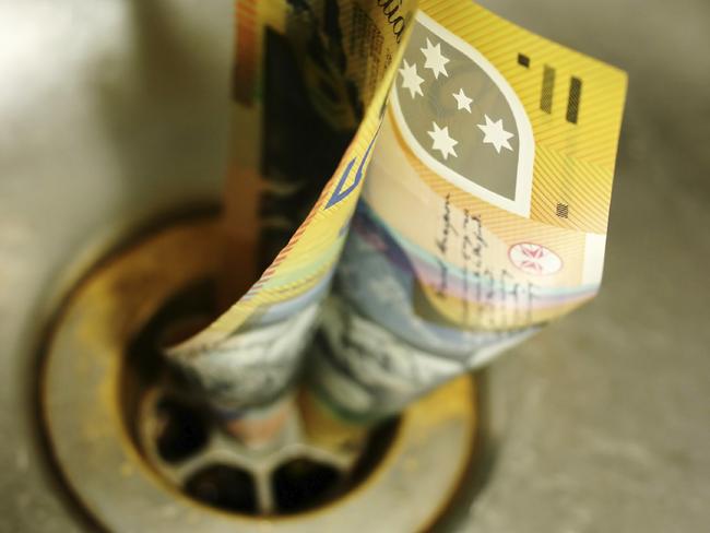 Generic image of Australian money going down the drain. Photo from iStock.