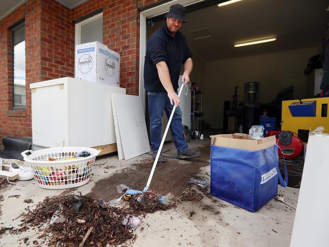 Matthew Willey begins the clean-up in his Euroa home. Picture: Alex Coppel.