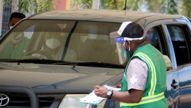 A driver attends a makeshift clinic in a sports stadium in Port Moresby. Picture: AFP