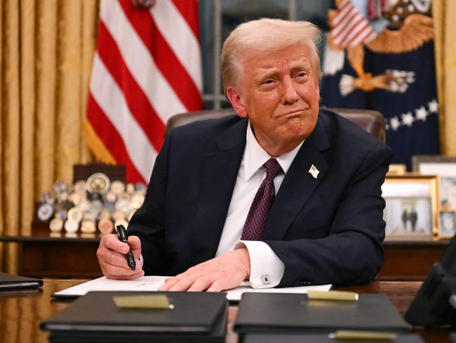 US President Donald Trump signs executive orders in the Oval Office of the White House in Washington, DC, on January 20, 2025. Picture: NewsWire / Jim WATSON / POOL / AFP