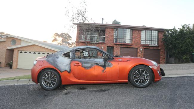 A car destroyed by the blaze in central Tathra. Picture: Gary Ramage