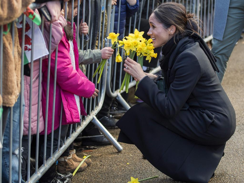 Britain’s Prince Harry’s fiancée US actress Meghan Markle receives flowers from a young well-wisher during a visit to Cardiff Castle in Cardiff, south Wales on January 18, 2018, for a day showcasing the rich culture and heritage of Wales. .Picture: AFP