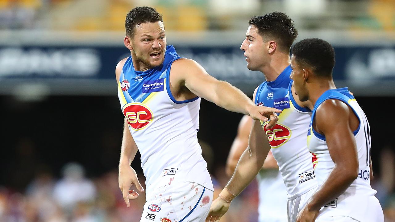 Gold Coast co-captain Steven May with Brayden Fiorini and Touk Miller.