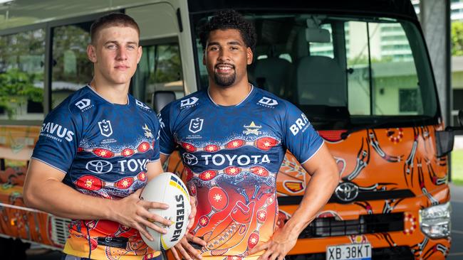 North Queensland Cowboys rugby league players Kaiden Lahrs and Jamal Shibasaki standing in front of a new ‘Nhinhinhi’-inspired Toyota Coaster. The 22-seat Coaster, donated by Toyota, provides daily transport for NRL Cowboys House boarding students. Picture: Supplied