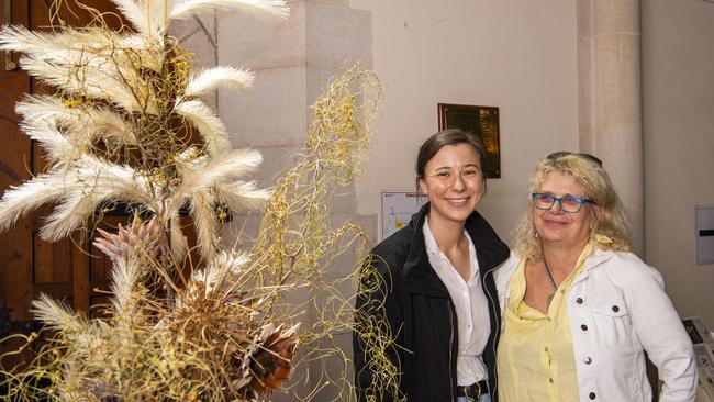 CARNIVAL MAGIC: Taking in the beautiful flower displays at St Luke’s Church on Saturday were Brisbane visitors Sasha (left) and Tess Paterson.