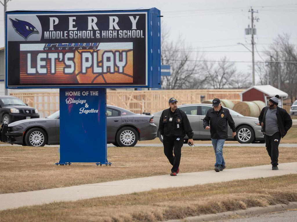 Police patrol the Perry Middle School and High School complex. (Photo by Christian Monterrosa / AFP)