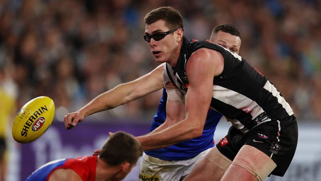 Steven May closes in on Mason Cox. Picture: Michael Klein