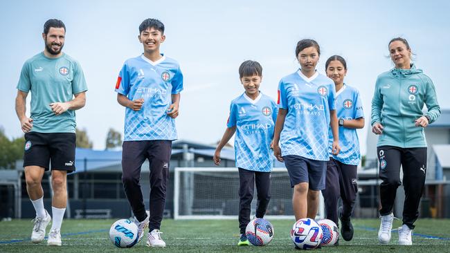 Melbourne City‘s Mat Leckie and former Matildas captain and City goalkeeper Melissa Barbieri with Omid Hasani (12), Umeed Haidri (11), Hannah Nguyen (11) and Yalda Ehsani (12). Picture: Jake Nowakowski