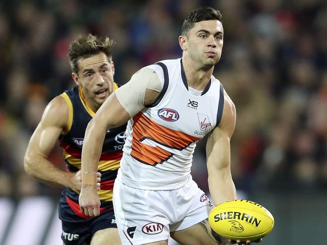 AFL - ROUND 12 - Adelaide Crows v GWS Giants at Adelaide Oval. Tim Taranto gets his handpass away from Richard Douglas. Picture SARAH REED