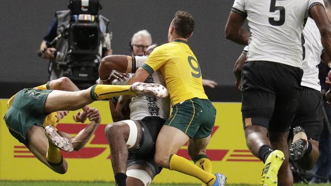 Australia's Reece Hodge (left) flies off Fiji’s Peleci Yato. Hodge has copped a three-match ban for the contact. Picture: AP