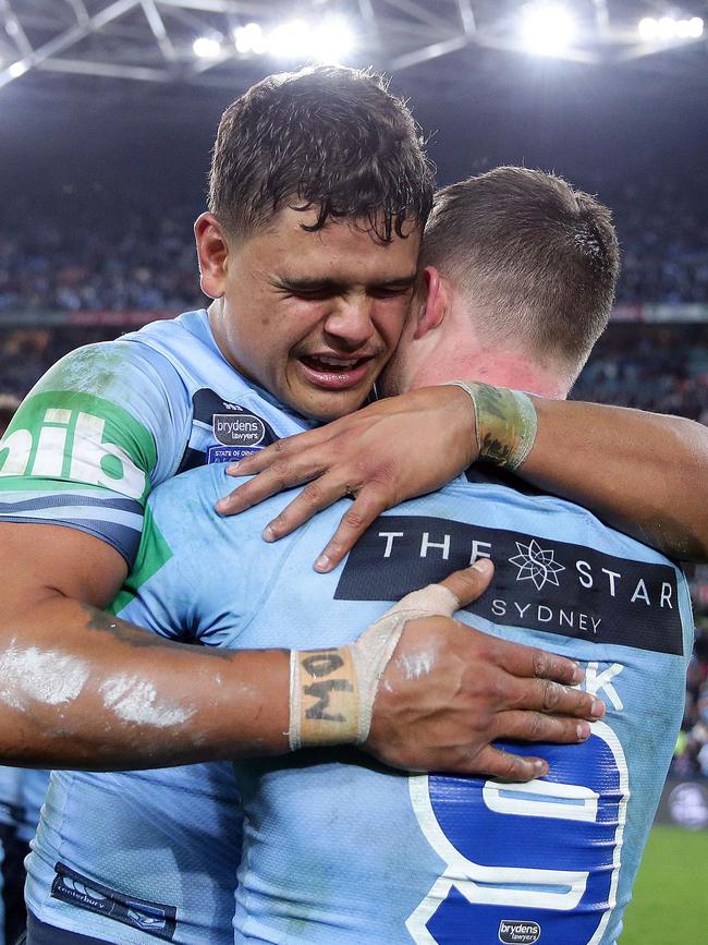 Latrell Mitchell (left) embraces Damien Cook after claiming State of Origin II. Photo: Brett Costello