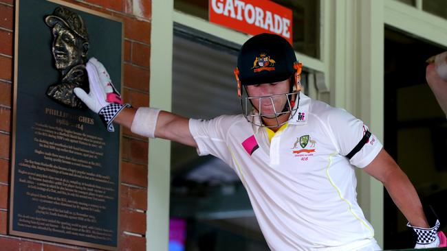 David Warner touches the Phillip Hughes plaque as he heads out to bat.