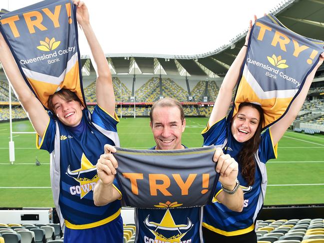 Queensland Country Bank CEO Aaron Newman (middle) with Cowboys supporters Kai Simmons, 17, and Victoria Fowler, 18, in their flip jerseys. Picture: Shae Beplate.